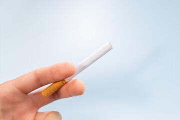 Hand holding a nicotine cigarette