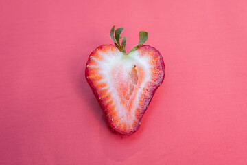 Single sliced strawberry on red
