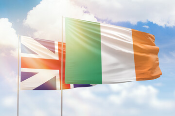 Sunny blue sky and flags of ireland and great britain