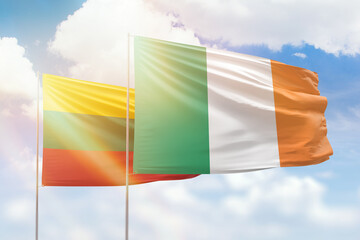 Sunny blue sky and flags of ireland and lithuania