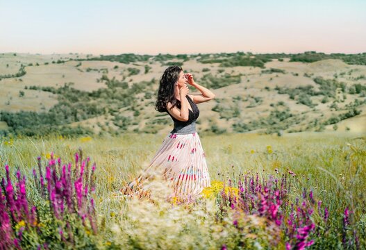 Woman In Purple Flowers Field