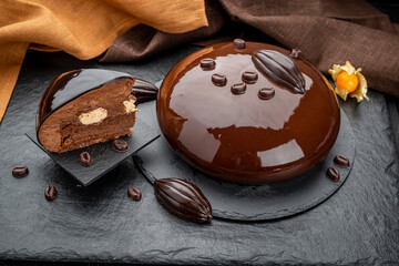 Still life of layered chocolate mousse cake covered with chocolate icing