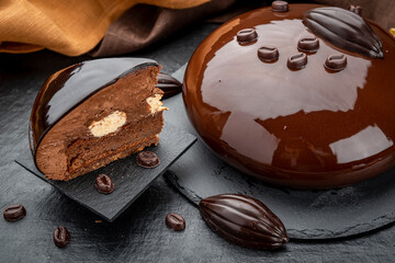 Still life of layered chocolate mousse cake covered with chocolate icing