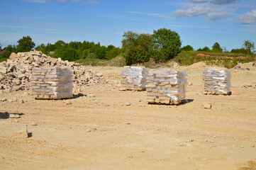 Quarry for the extraction and development of limestone. The collected stones are neatly stacked on...