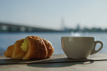 A cup of delicious aromatic coffee on the table