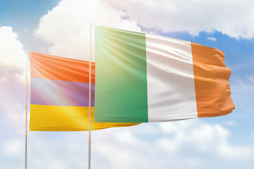 Sunny blue sky and flags of ireland and armenia