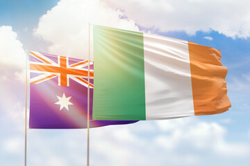 Sunny blue sky and flags of ireland and australia