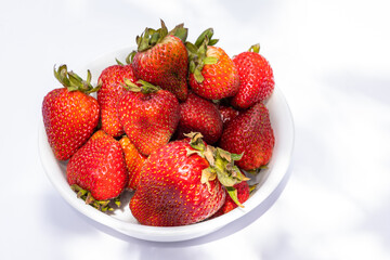 Bowl of strawberries on a white background