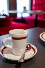 Small cup of black espresso coffee served in traditional cafe in Vienna with red interieur, Austria