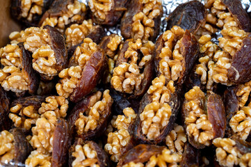 Turkish or arabic sweet dessert, ripe dried dadels with walnuts sweetened with syrup or honey.