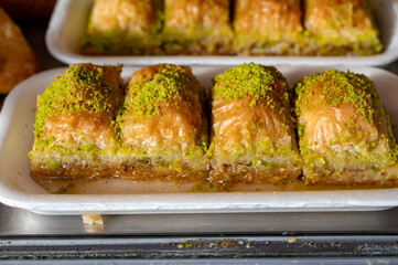 Turkish or arabic sweet dessert, baklava made from filo pastry, filled with chopped pistachio nuts and sweetened with syrup or honey.