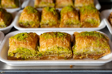 Turkish or arabic sweet dessert, baklava made from filo pastry, filled with chopped pistachio nuts and sweetened with syrup or honey.