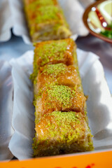 Turkish or arabic sweet dessert, baklava made from filo pastry, filled with chopped pistachio nuts and sweetened with syrup or honey.