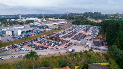 Yard of abandoned cars and seized for irregularity by the police. With many cars and many motorcycles parked. Aerial view