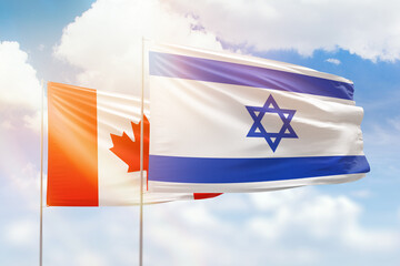 Sunny blue sky and flags of israel and canada