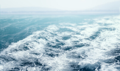 Naklejka na ściany i meble Beautiful sea waves with a lot of foam and bubbles on surface .