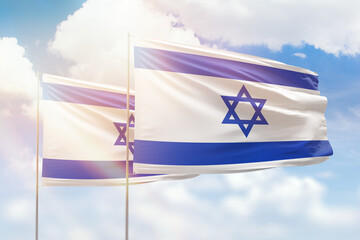 Sunny blue sky and flags of israel and israel
