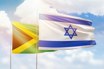 Sunny blue sky and flags of israel and jamaica