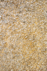 Background, texture of pressed wood, boards, sawdust on the wall.