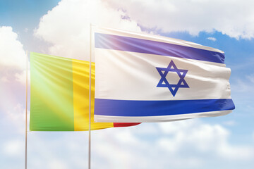 Sunny blue sky and flags of israel and mali