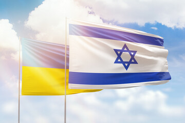 Sunny blue sky and flags of israel and ukraine