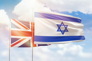 Sunny blue sky and flags of israel and united kingdom