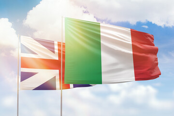 Sunny blue sky and flags of italy and great britain
