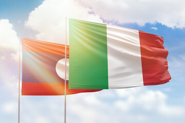Sunny blue sky and flags of italy and laos