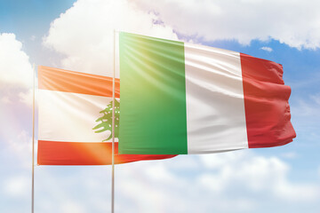 Sunny blue sky and flags of italy and lebanon