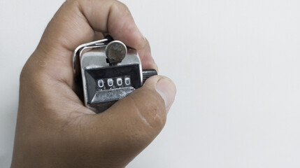Hand held tally counter isolated on white background, reset the counter for start from zero.
