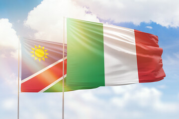 Sunny blue sky and flags of italy and namibia