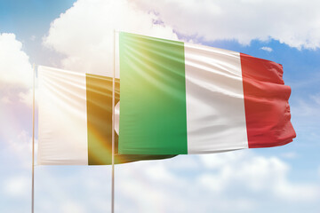 Sunny blue sky and flags of italy and pakistan