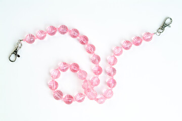 Obraz premium pink necklace on white background isolated