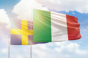 Sunny blue sky and flags of italy and sweden