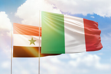 Sunny blue sky and flags of italy and syria
