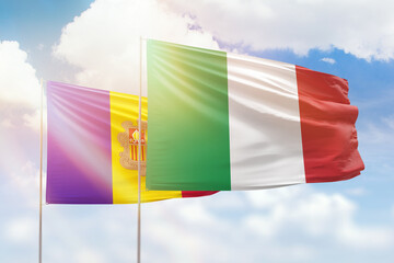 Sunny blue sky and flags of italy and andorra