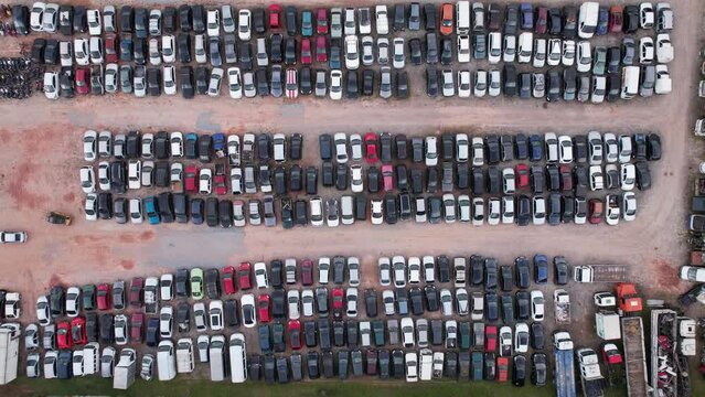 Yard of abandoned cars and seized for irregularity by the police. With many cars and many motorcycles parked. Aerial view