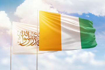 Sunny blue sky and flags of ivory coast and afghanistan
