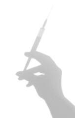 Shadow of a hand with a syringe