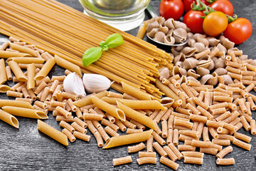 Pasta different whole grain and rye on dark board