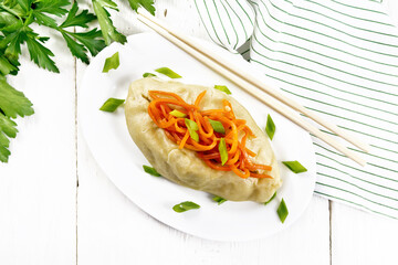 Pegodi with spicy carrots in plate on light board top