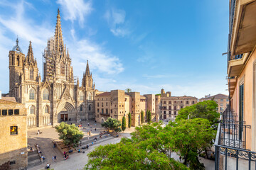 View of the Gothic Cathedral of the Holy Cross and Saint Eulalia, also known as Barcelona Cathedral from a balcony terrace across the plaza in the Catalonia city of Barcelona, in Southern Spain. - obrazy, fototapety, plakaty