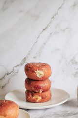Doughnuts with Creamy Lemon Filling Dusted on white background. copy space for your text. Snack food and dessert.