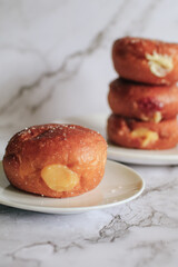 Doughnuts with Creamy Lemon Filling Dusted on white background. copy space for your text. Snack food and dessert.