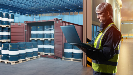 Oil logistics. Man with laptop next to warehouse. Blue barrels near container. Sea container for...