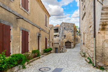 Fototapeta na wymiar A typical stone street through the historic medieval village of Les Baux-de-Provence in the Alpilles Mountains of the Provence-Alpes-Cote d'Azur region of Southern France.