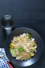 Healthy food fried rice with chicken breast have vegetable on wood table.