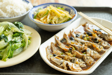 angle view fast food of steamed small fishes and cabbage and potato slices with rice horizontal composition