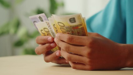 African American teenager counting money cash close-up. Rich young businessman holding euro banknotes, currency. Financial success, profit and wealth. - Powered by Adobe