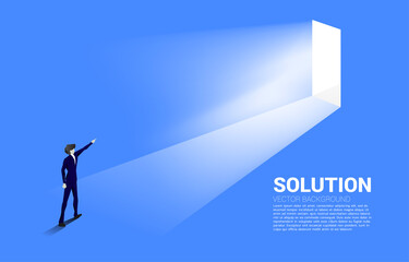 Silhouette of businessman point ahead to exit door. Concept of career start up and business solution.